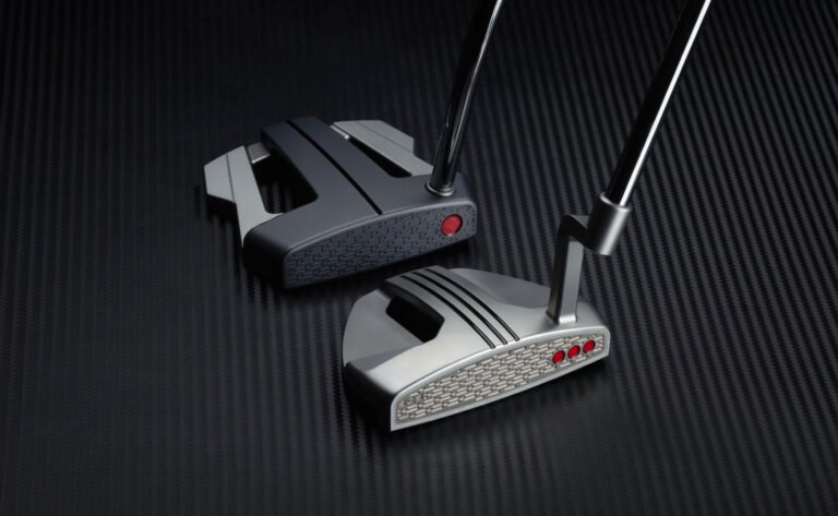 Two golf clubs resting on a dark textured surface, highlighting metallic club heads and shafts.